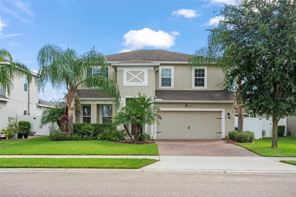 view of front facade featuring a front yard and a garage