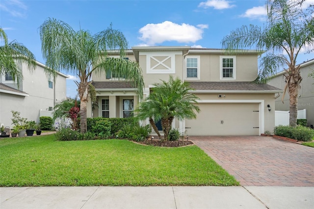 view of front of property featuring a garage and a front yard