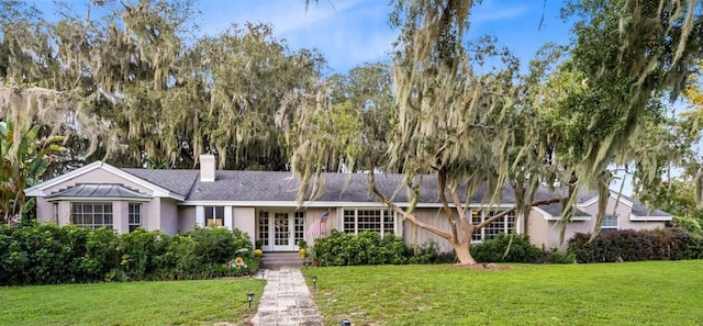 view of front of property featuring a front yard and french doors