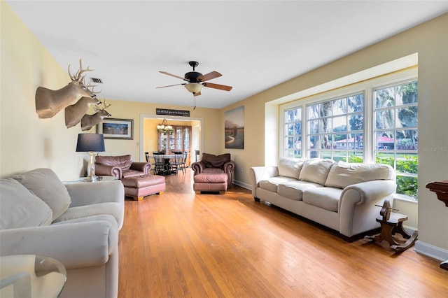 living room featuring light wood-type flooring and ceiling fan