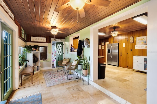 interior space featuring wood walls and wooden ceiling