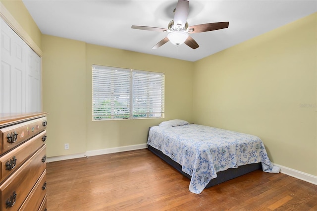 bedroom featuring a closet, wood-type flooring, and ceiling fan