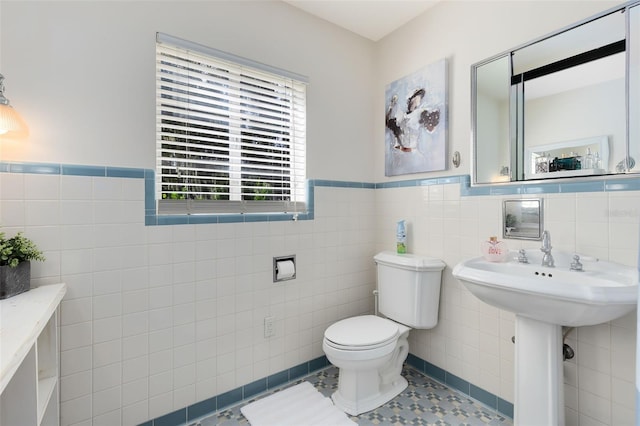 bathroom featuring tile walls, toilet, and tile patterned floors