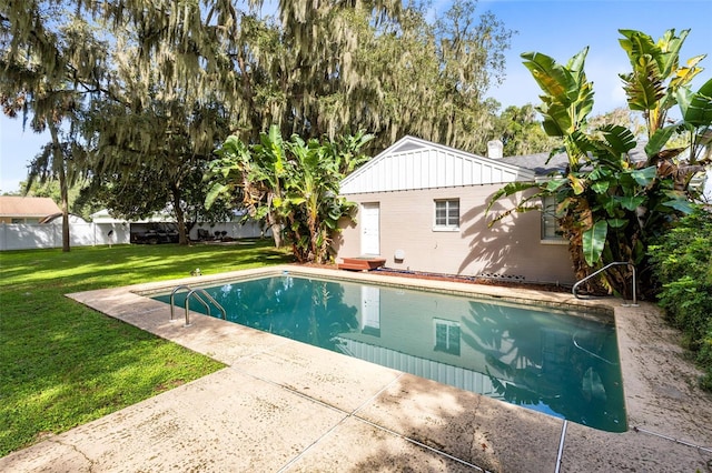 view of swimming pool with a patio and a yard