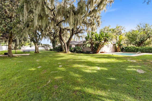 view of yard with a fenced in pool