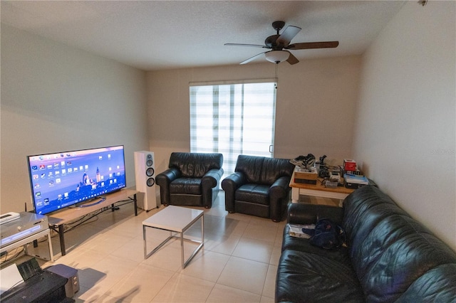 living room with a textured ceiling and ceiling fan