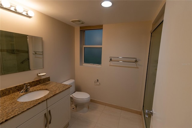 bathroom featuring walk in shower, vanity, toilet, and tile patterned floors