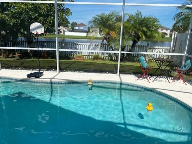 view of pool with a lawn