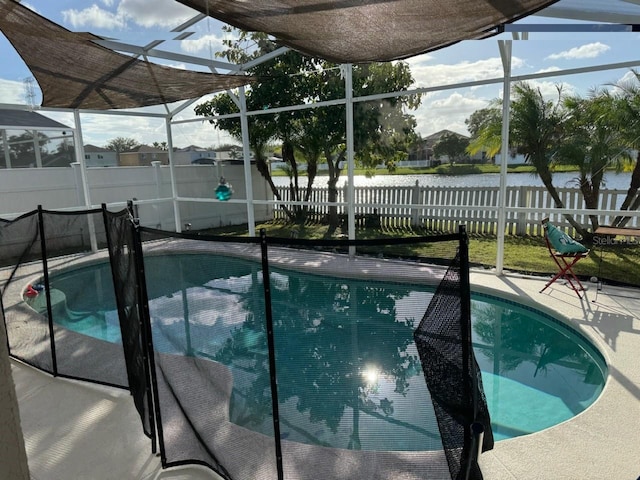 view of swimming pool featuring a patio, a water view, and a lanai