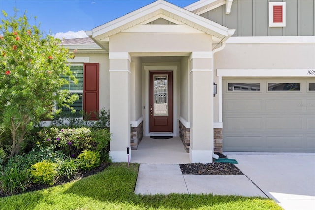 view of exterior entry featuring a garage