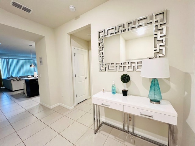 hall featuring light tile patterned floors