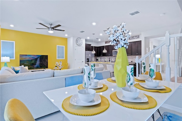 dining space with light tile patterned floors and ceiling fan