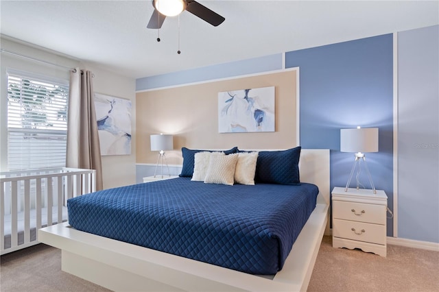 bedroom featuring light colored carpet and ceiling fan