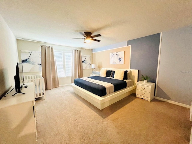 bedroom with light colored carpet and ceiling fan