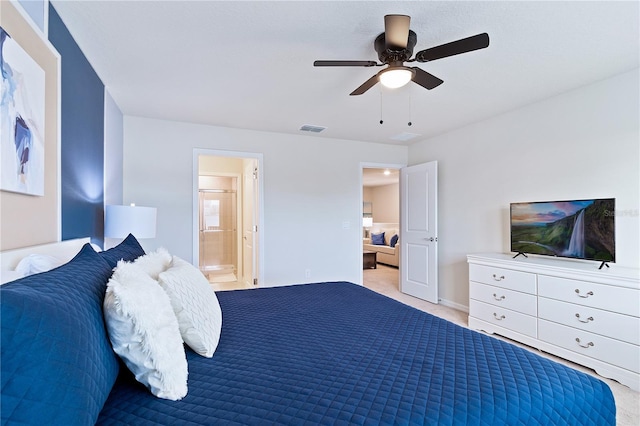 bedroom featuring light colored carpet, ceiling fan, and ensuite bath