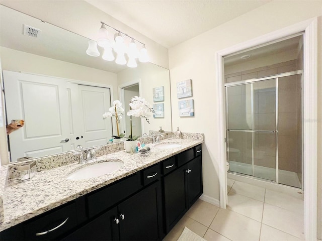 bathroom with vanity, toilet, walk in shower, and tile patterned flooring