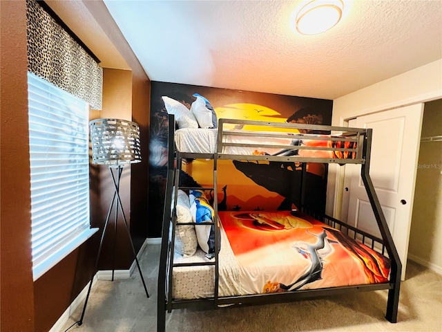 bedroom with a textured ceiling and carpet floors