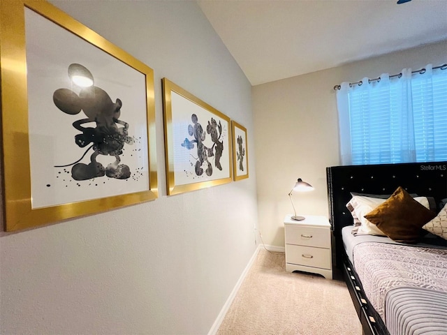 bedroom featuring light carpet and vaulted ceiling