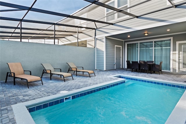 view of pool with a patio area and a lanai