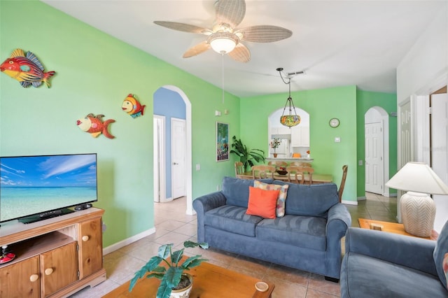 living room with ceiling fan and light tile patterned floors