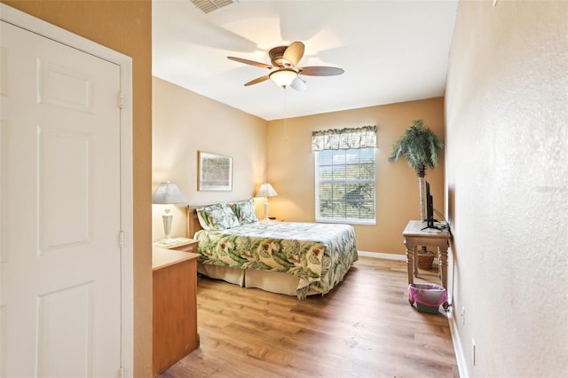 bedroom featuring ceiling fan and hardwood / wood-style floors