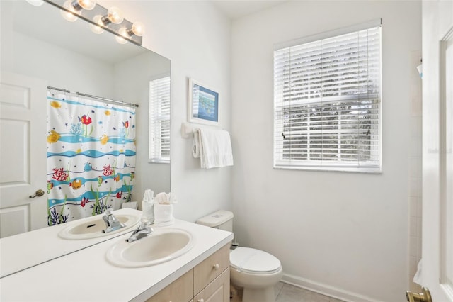 bathroom featuring a shower with curtain, vanity, toilet, and tile patterned floors