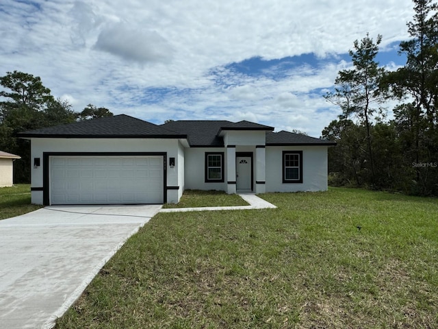 view of front of property with a garage and a front lawn