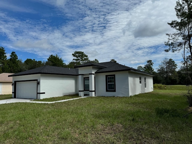 view of front of house featuring a garage and a front lawn