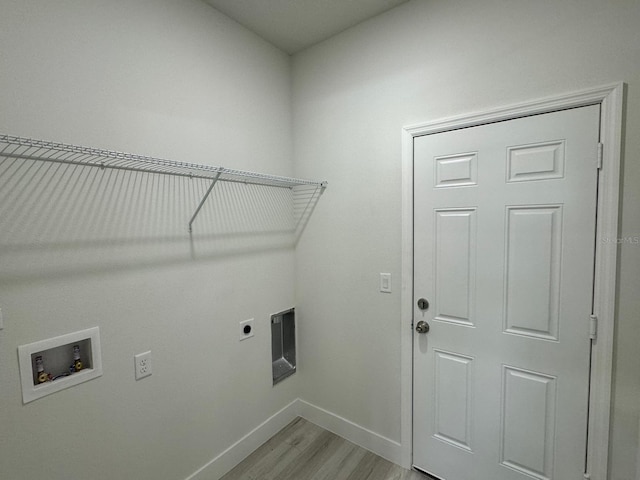 washroom featuring hookup for an electric dryer, light hardwood / wood-style floors, and hookup for a washing machine