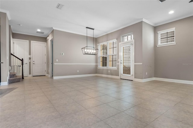 interior space featuring ornamental molding, plenty of natural light, and an inviting chandelier