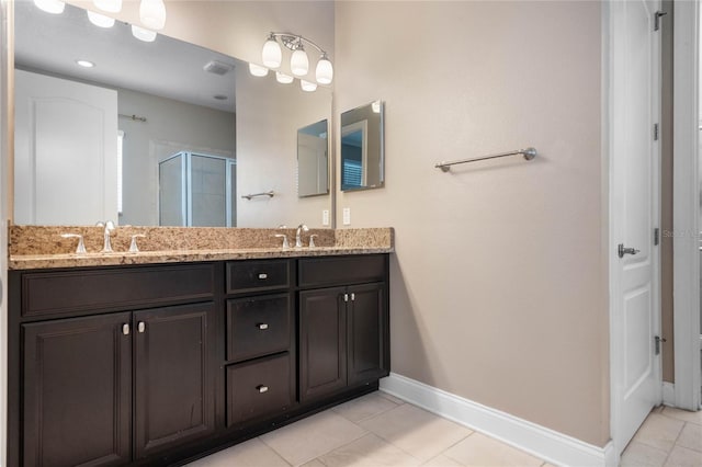 bathroom featuring an enclosed shower, tile patterned flooring, and vanity