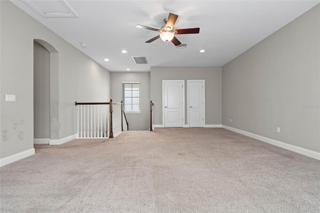 spare room with light carpet and ceiling fan