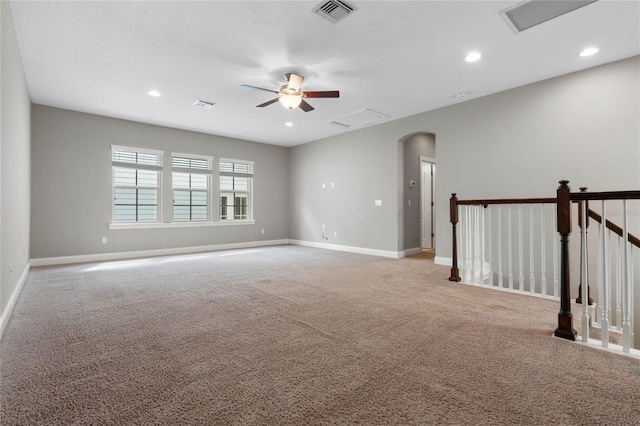 carpeted empty room featuring ceiling fan