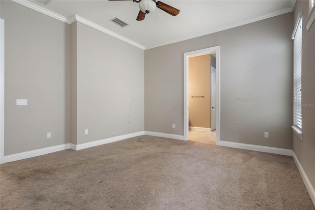 carpeted empty room with ornamental molding, a healthy amount of sunlight, and ceiling fan