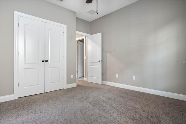 unfurnished bedroom with a closet, carpet, and ceiling fan