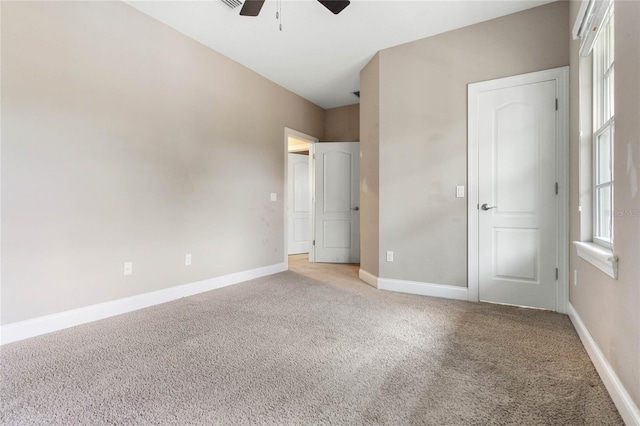 unfurnished bedroom featuring light colored carpet and ceiling fan