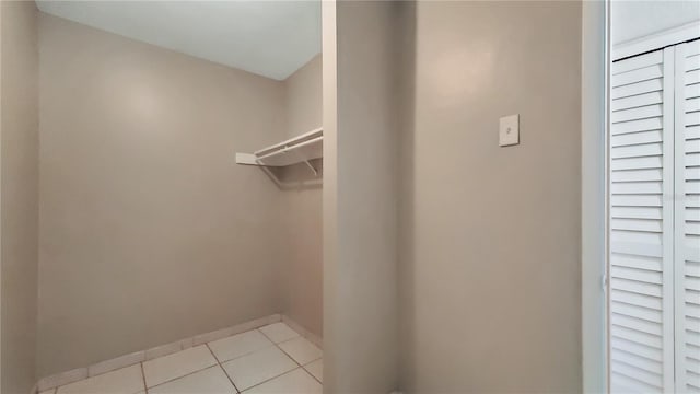 spacious closet featuring light tile patterned floors