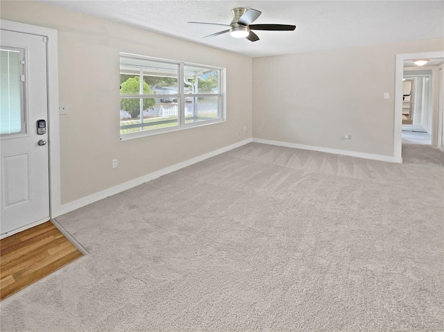 interior space featuring carpet floors and ceiling fan