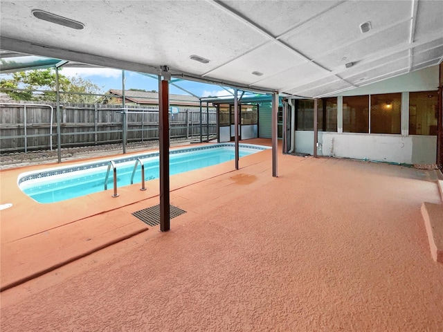 view of pool with a patio and glass enclosure