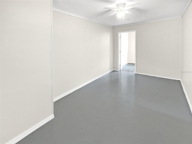 spare room with ceiling fan, crown molding, and concrete floors