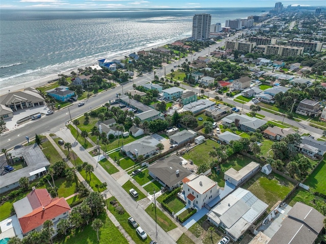 drone / aerial view featuring a water view and a beach view