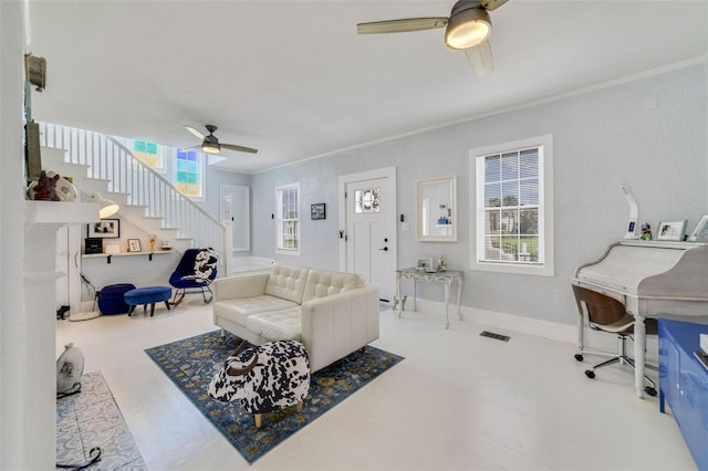 living room featuring ceiling fan and a wealth of natural light