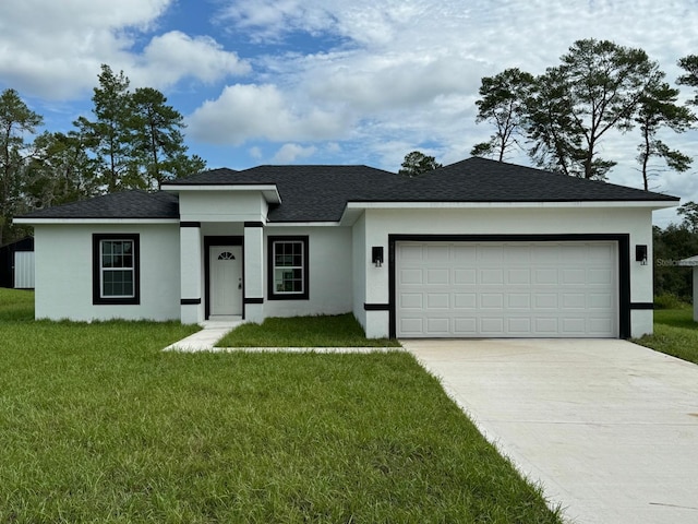 view of front of property featuring a garage and a front yard