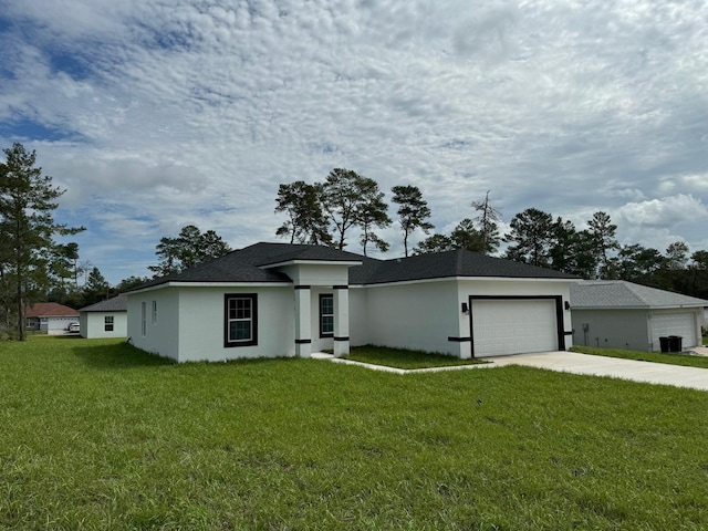 view of front of property featuring a front yard and a garage