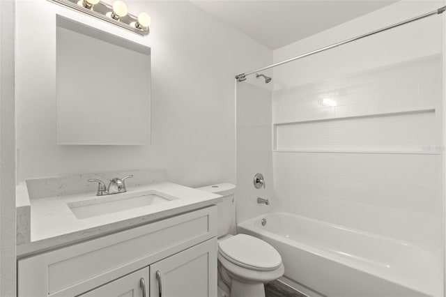 full bathroom with tiled shower / bath, vanity, and toilet