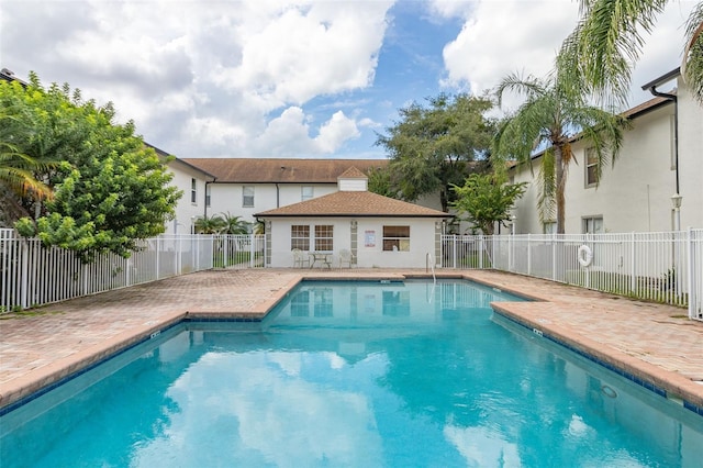 view of pool featuring an outbuilding and a patio area