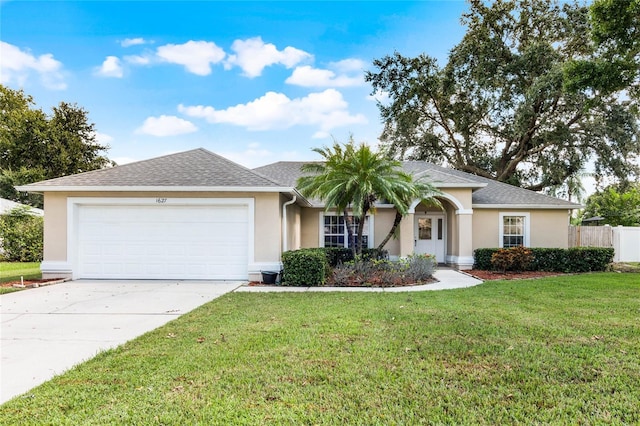 ranch-style house with a garage and a front lawn