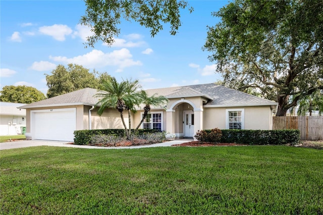 ranch-style house featuring a front yard and a garage