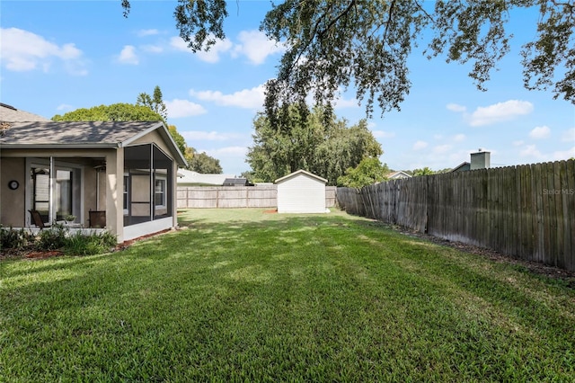 view of yard with a sunroom and a shed