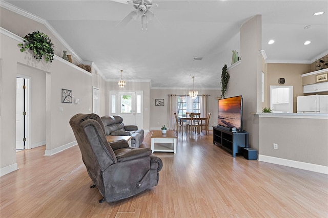 living room featuring ceiling fan with notable chandelier, light hardwood / wood-style floors, and ornamental molding